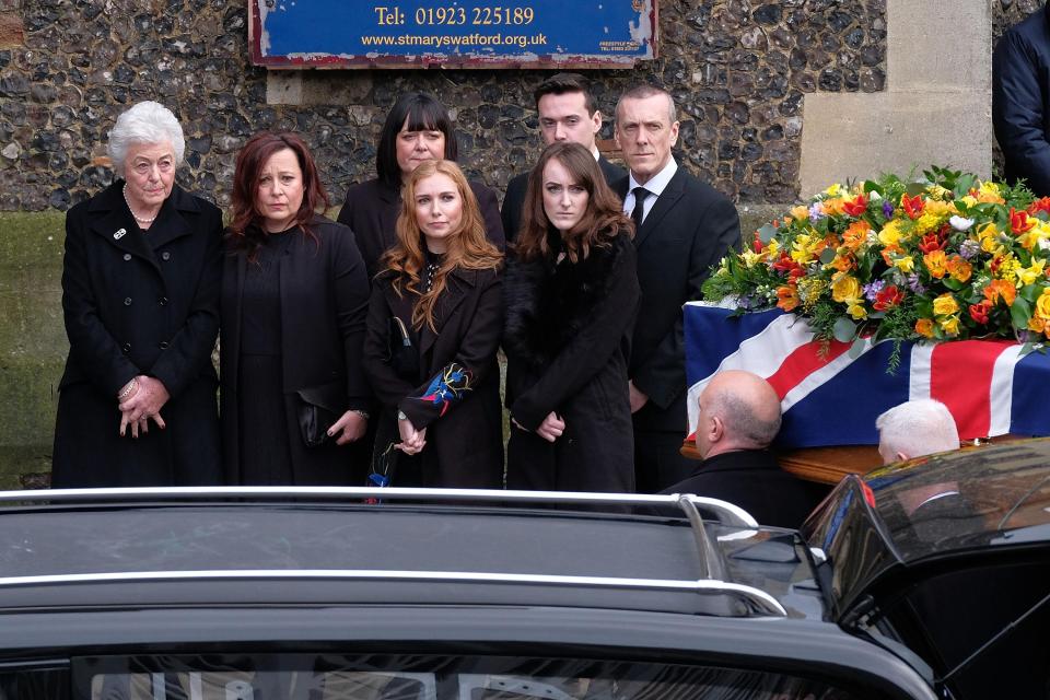  Taylor's wife Rita, far left, and his daughters Karen (second from left) and Joanne (third from left) watch on as his coffin is carried into the St Mary's church in Watford on Wednesday