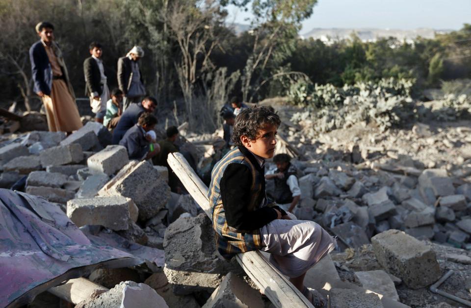  A Yemeni boy sits amid rubble of damaged houses following reported Saudi-led coalition air strikes on the outskirts of the Yemeni capital Sanaa on February 1