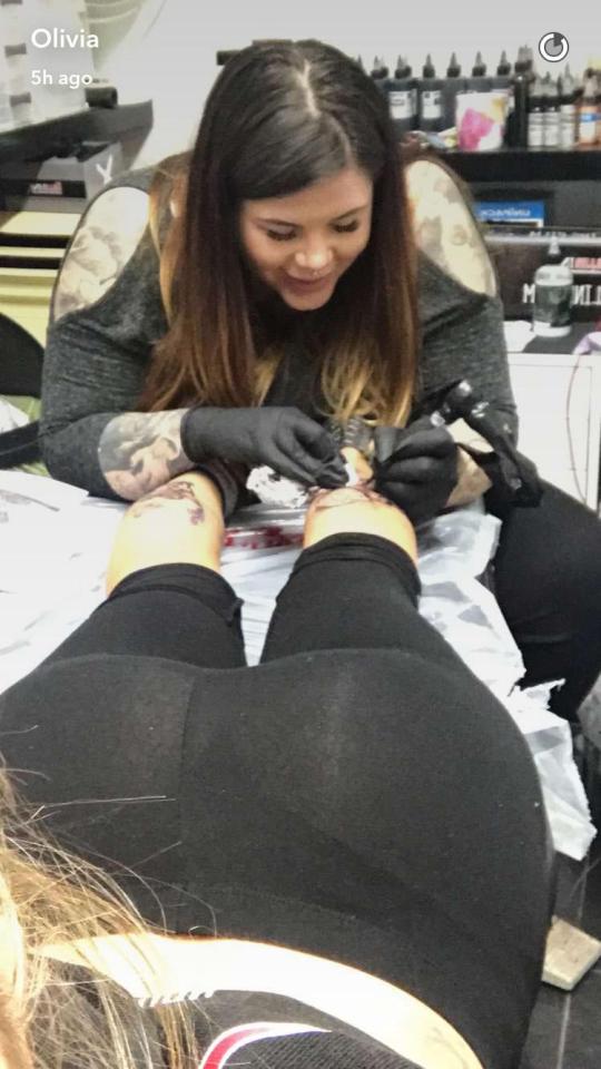  She captured the tattoo artist getting to work on both her calves