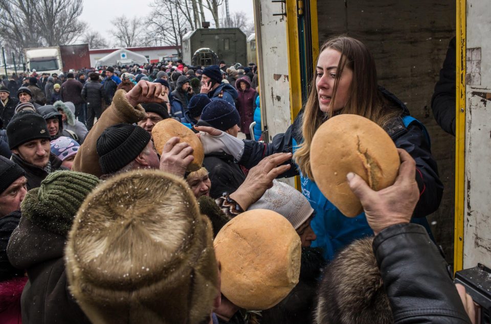  Bread is distributed to civilians by workers from the UN Refugee Agency