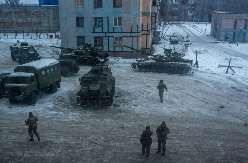  Ukrainian soldiers and tanks outside a building used as a base in Avdiivka