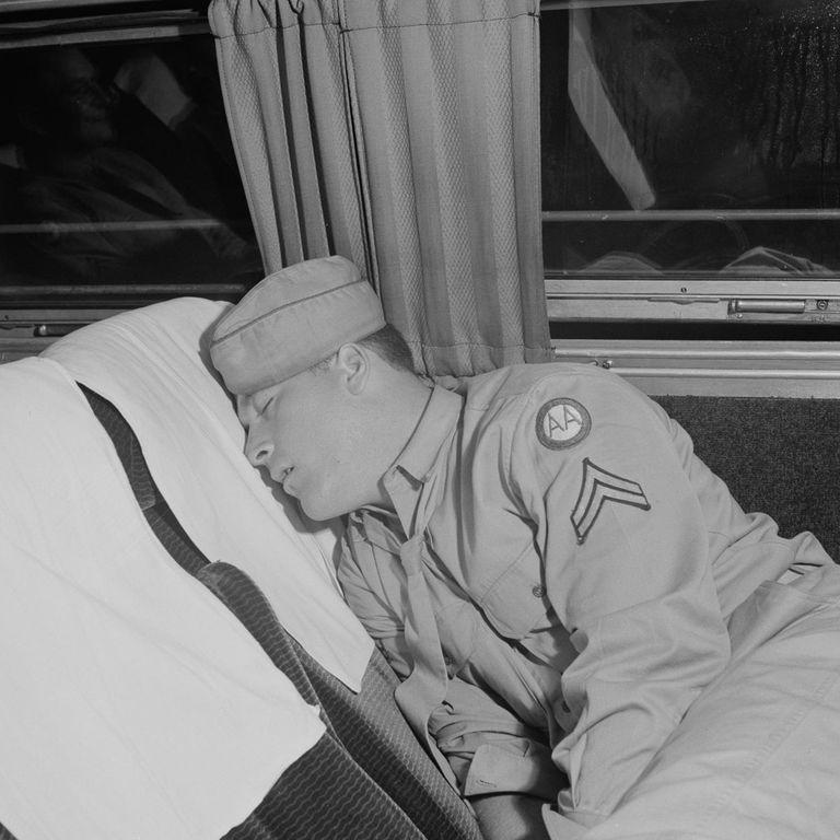  An army man catches up on sleep in his seat