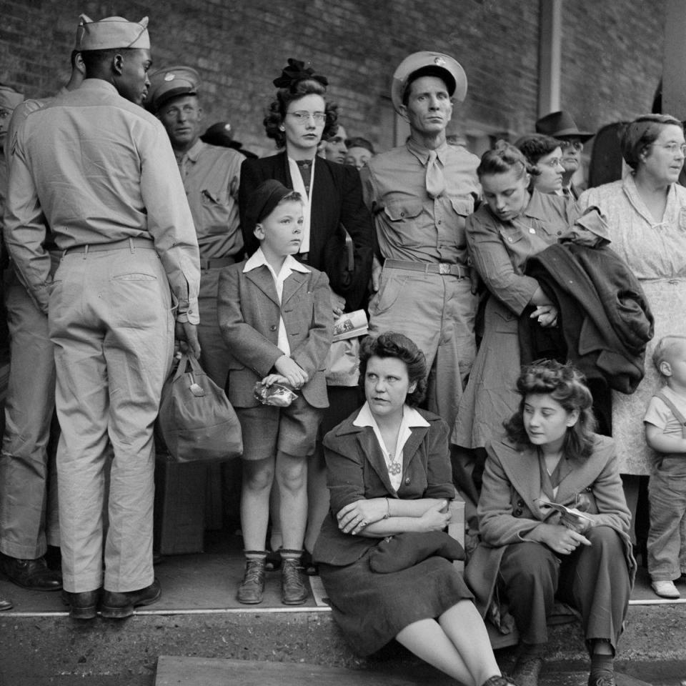  A cross-section of American society wait to board their bus