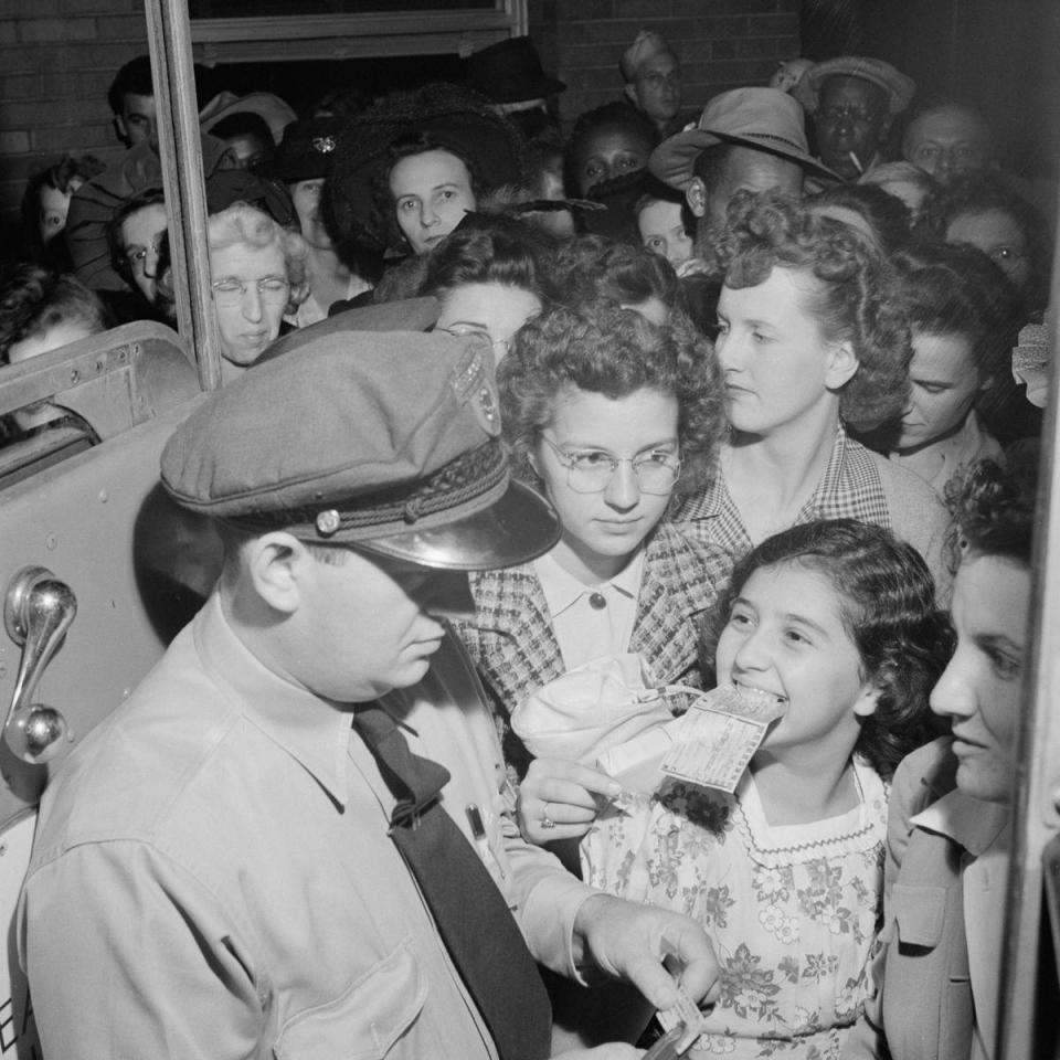  A young passenger grins at the coach driver as they get ready to board their bus