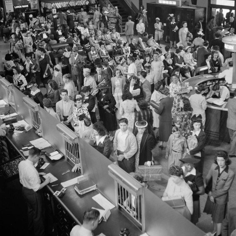  Travellers queue for tickets in a busy coach station