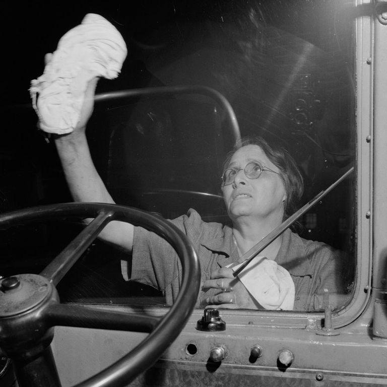  A member of staff gives the coach windscreen a clean before it departs the station