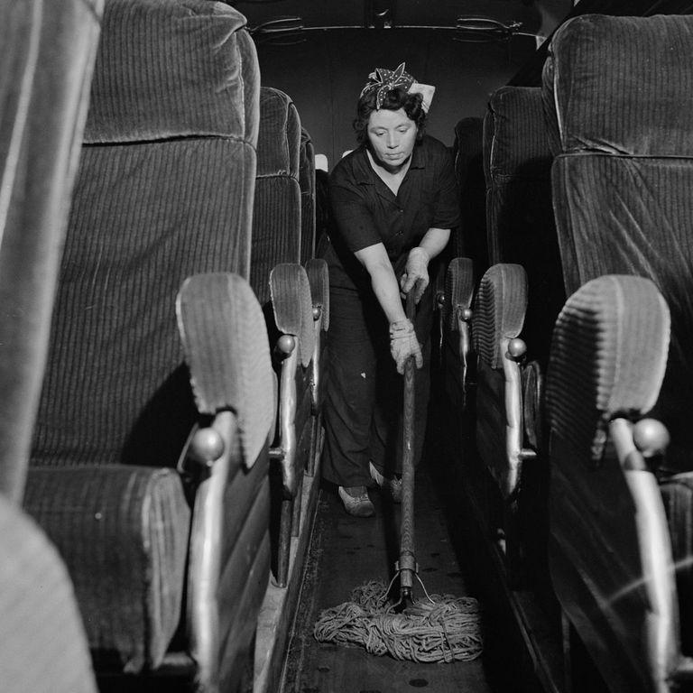  A cleaner mops the aisle of a Greyhound bus after passengers have disembarked