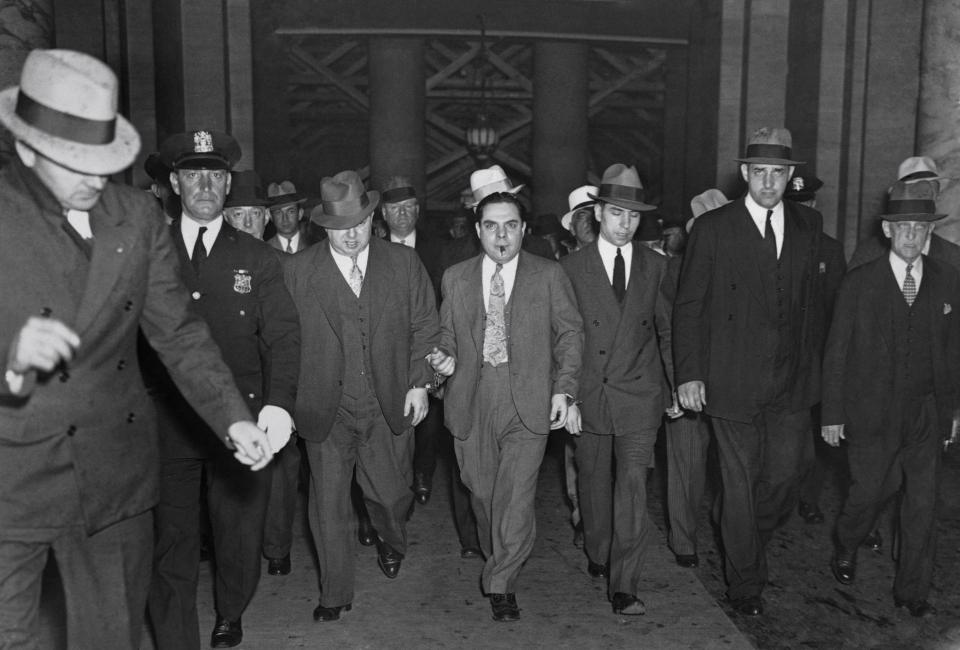  Charles (Lucky) Luciano, makes his way to court before he was convicted as the dictator of organised vice in New York City