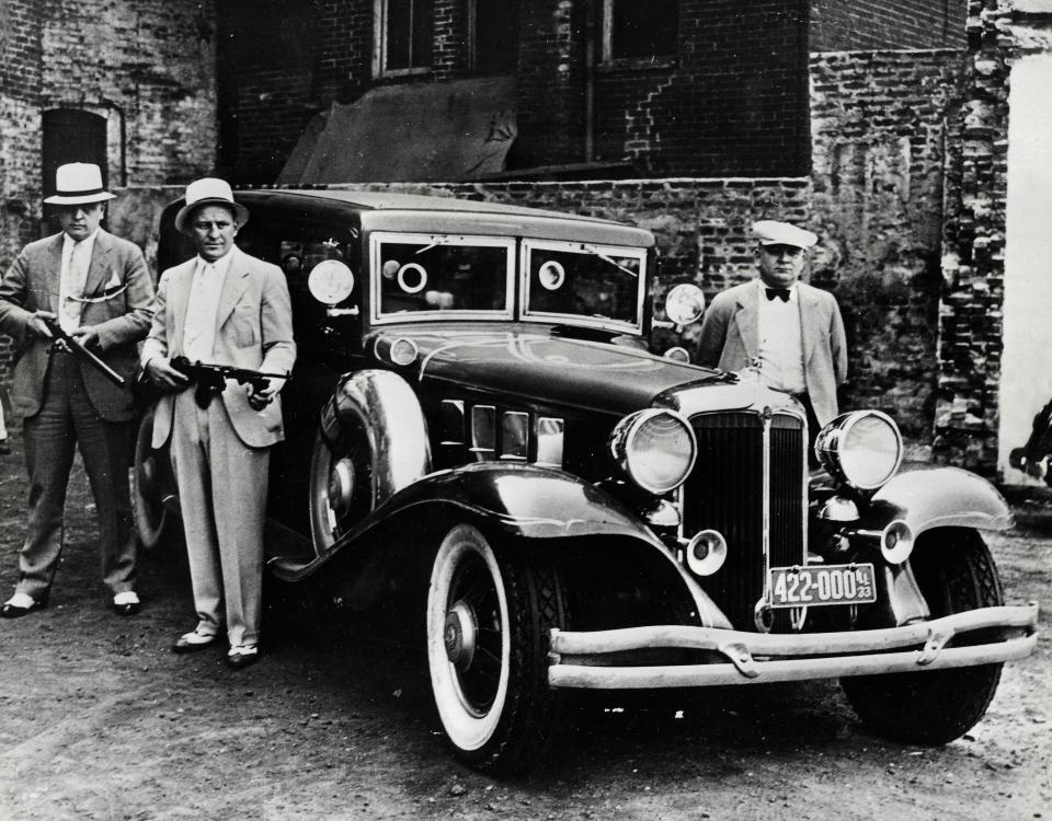  Chicago gangsters stand around an armoured car that was designed for mobsters