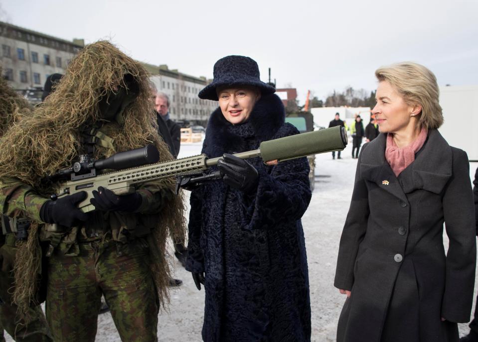  German Defense Minister Ursula von der Leyen, right, and Lithuania's Presidend Dalia Grybauskaite speaks with a soldier wearing camouflage