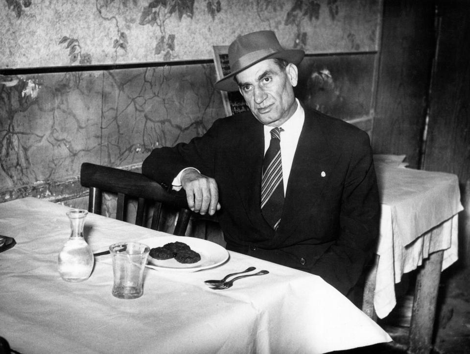  Italian-American mafioso Frank Frigenti sits at a table in a restaurant in 1930