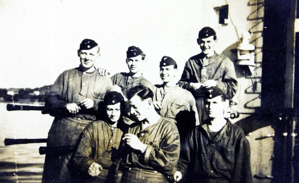  Crew members enjoy a cigarette while sharing a joke together