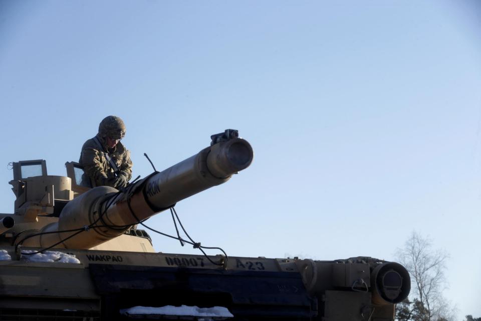  A soldier unloads a M1 Abrams tank to be tested across Latvia