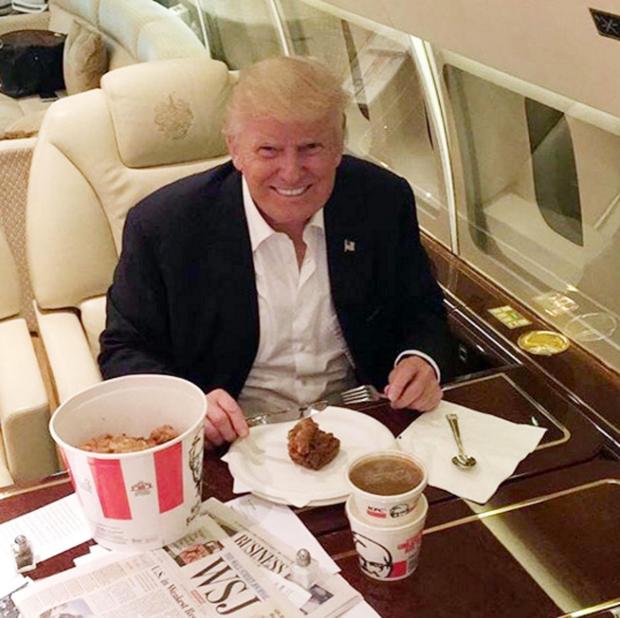 Donald Trump looking as happy as Larry with his KFC