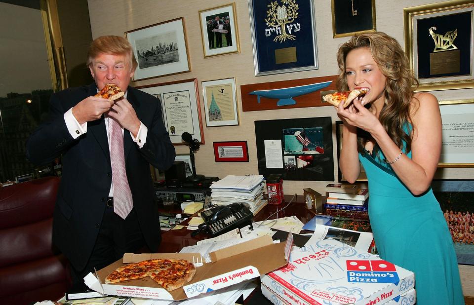  Trump takes some time out from his busy schedule to feast with a member of his staff on a Domino's Pizza