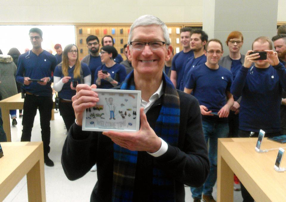  Cook poses with a picture drawn for him by iStaff