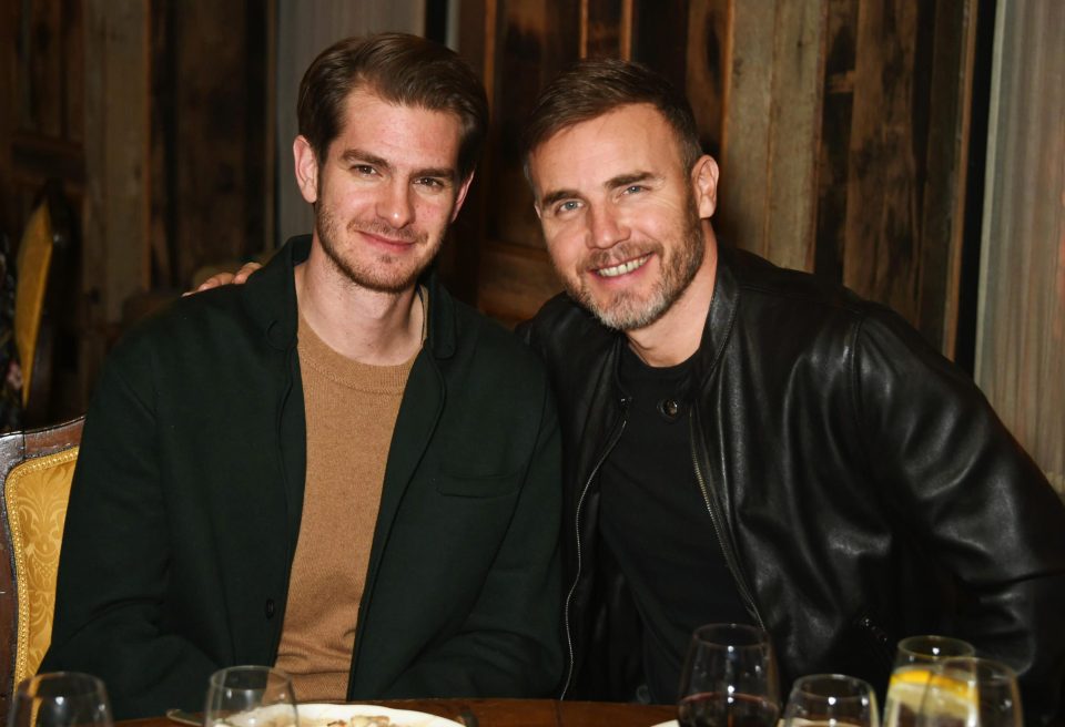  Andrew Garfield and Gary Barlow sit next to one another for a bit to eat