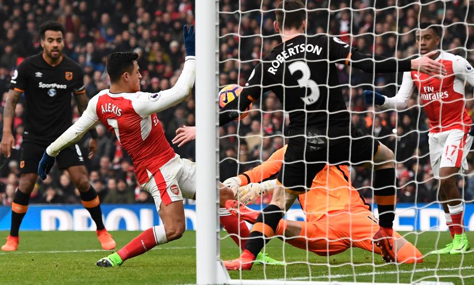  Arsenal star man Alexis Sanchez is first to a loose ball in the Hull box