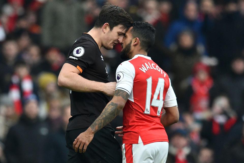  Theo Walcott earned himself a yellow card for squaring up to Hull's giant centre-back Harry Maguire