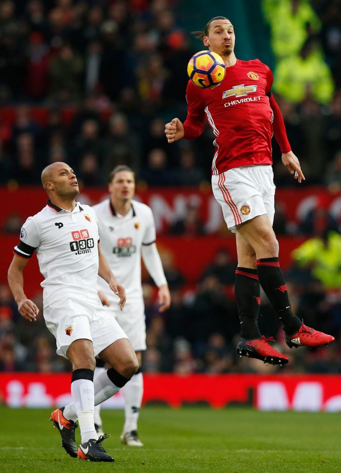  Ibrahimovic leaps to beat Kaboul to the ball during the 2-0 win at Old Trafford