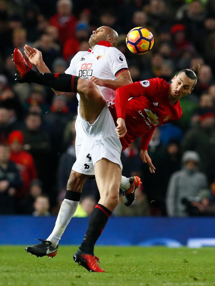  Ibrahimovic battles for the ball with fellow powerhouse Younes Kaboul