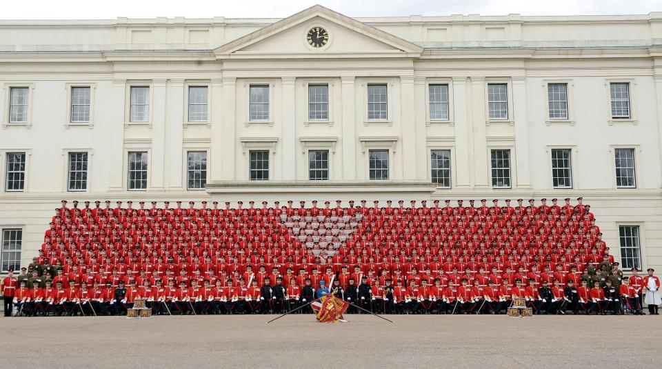  Queen Elizabeth II poses with the Grenadier Guards in Wellington Barracks, after presenting them with their new colours. The barracks has reportedly faced major problems with boilers