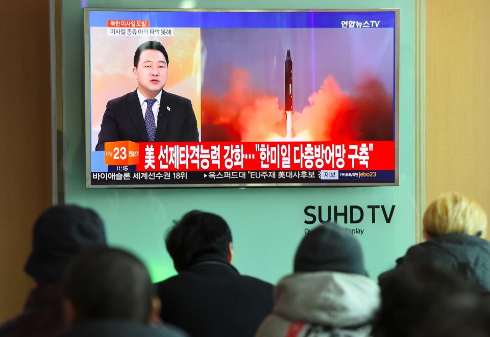  People in Seoul, South Korea watch the news showing file footage of North Korea's missile launch