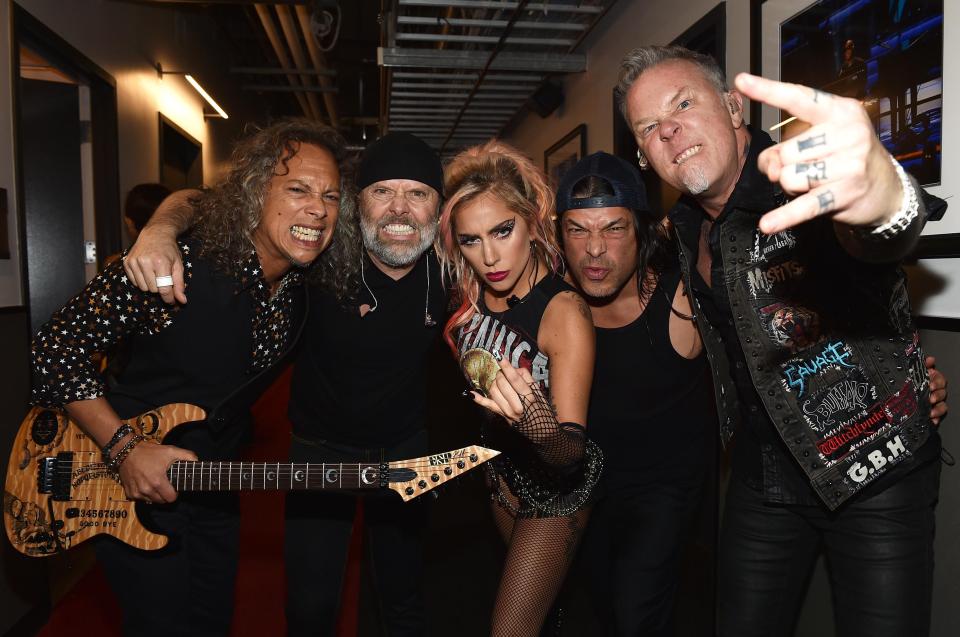  Gaga posed with the band backstage in her stage costume