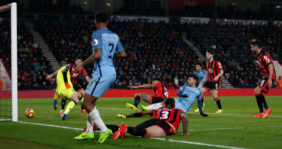  Sergio Aguero slots home the second with the help of a deflection to seal all three points