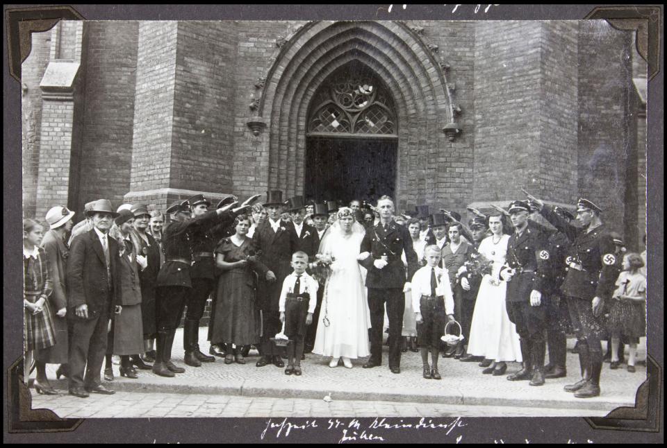  An SS officer receives the Nazi salute from other party members on his wedding day