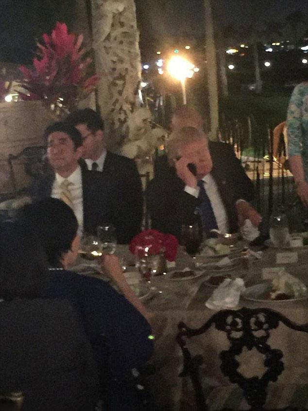  Trump pictured on his phone in a public restaurant after North Korea's missile test on Saturday