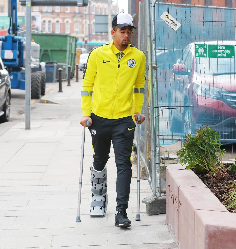 Gabriel Jesus looks dejected as he wanders down the street with foot in a cast