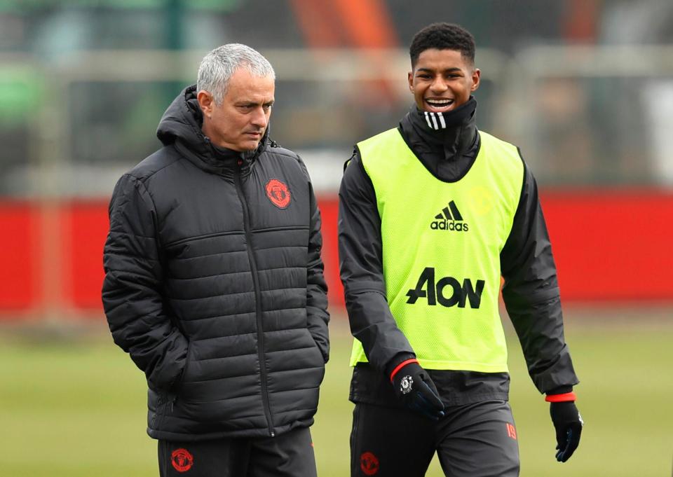 Marcus Rashford laughs alongside boss Jose Mourinho during training