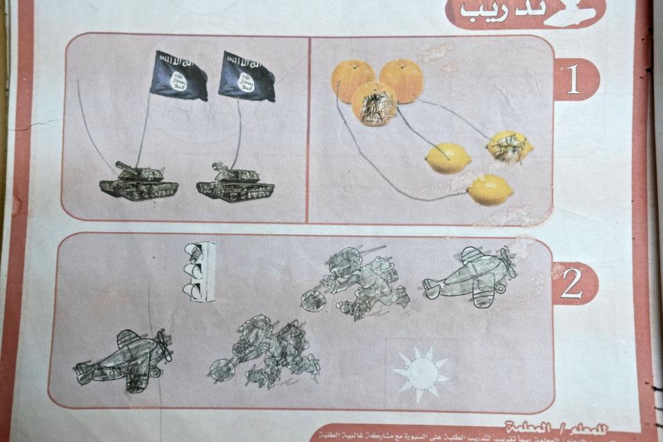  Tanks bearing the ISIS flag are seen next to oranges and lemons in this bizarre page from a textbook