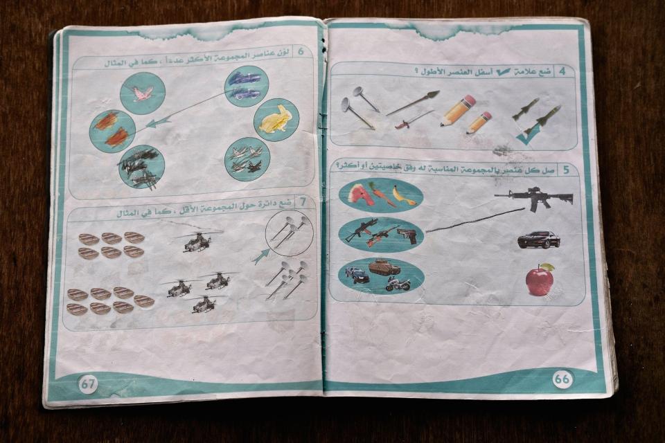  Swords and spears can be seen next to two pencils on a page from one of the books found in Mosul, northern Iraq