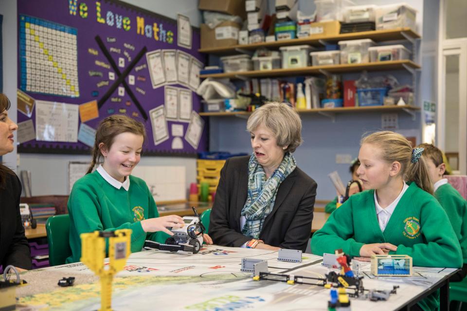  Theresa May did not look impressed by a schoolgirl's Lego robot