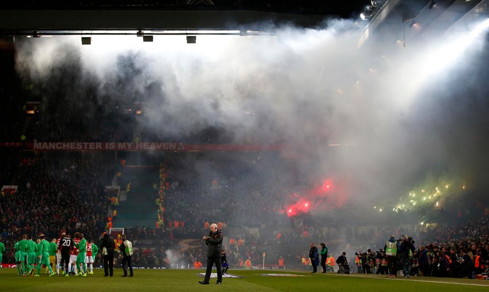  Fans began to light their flares as the players lined up at Old Trafford