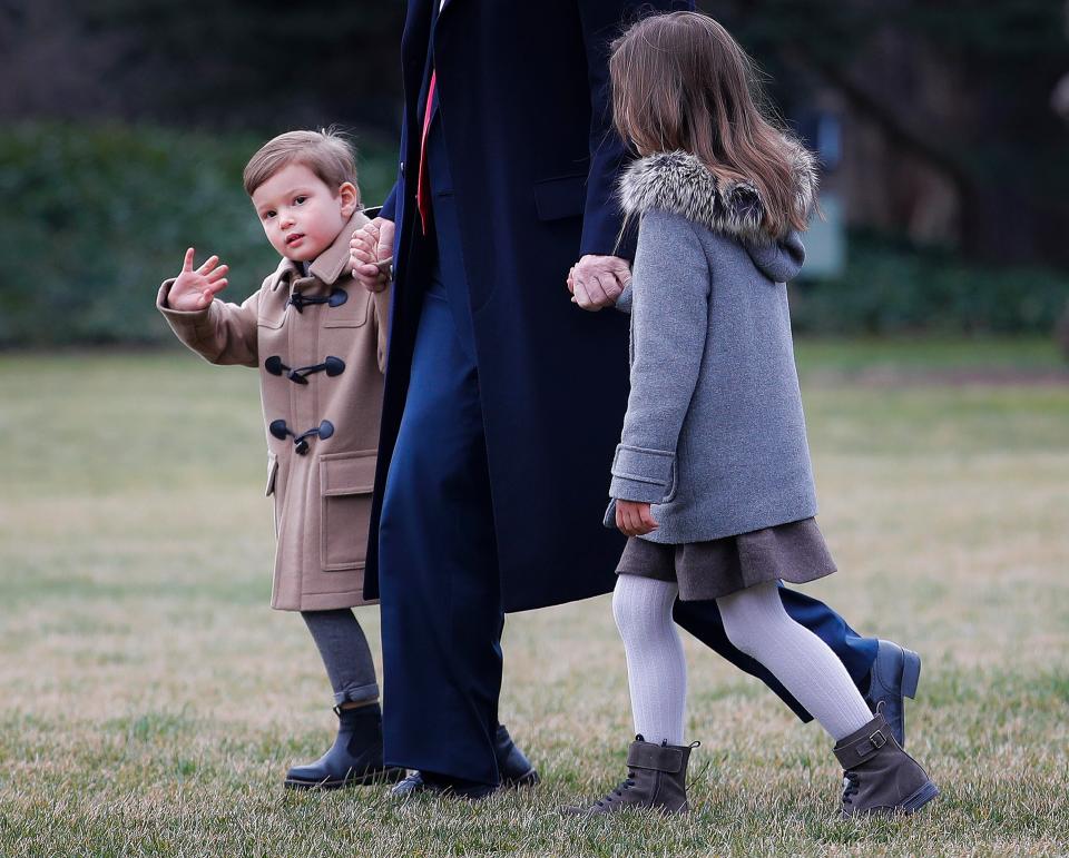  Joseph waves at reporters as he makes his way across the lawn towards the helicopter