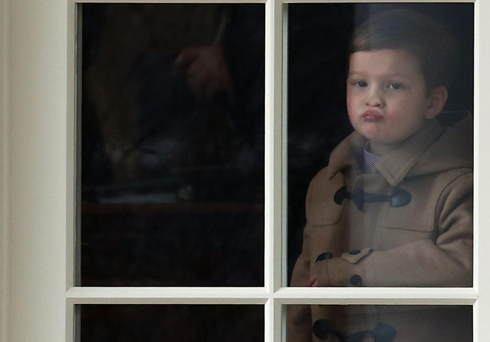  Joseph pulls faces as he stands in the window of the Oval Office today