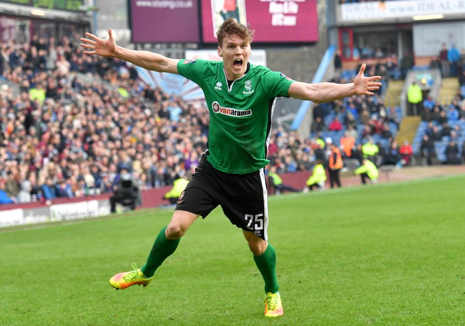  Lincoln City's Sean Raggett celebrates after his winner against Burnley - and they could face Arsenal away