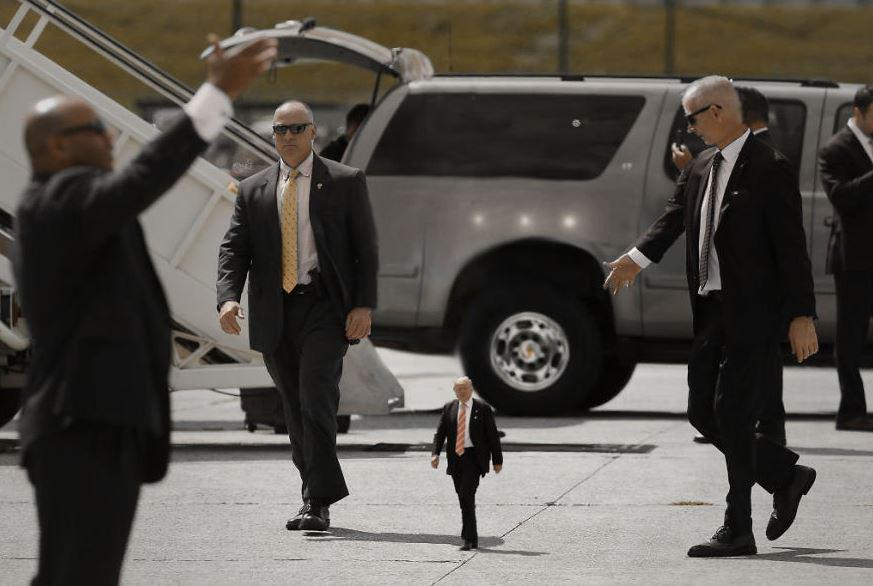  Tiny Trump's aides help him along in one of the tweaked photos