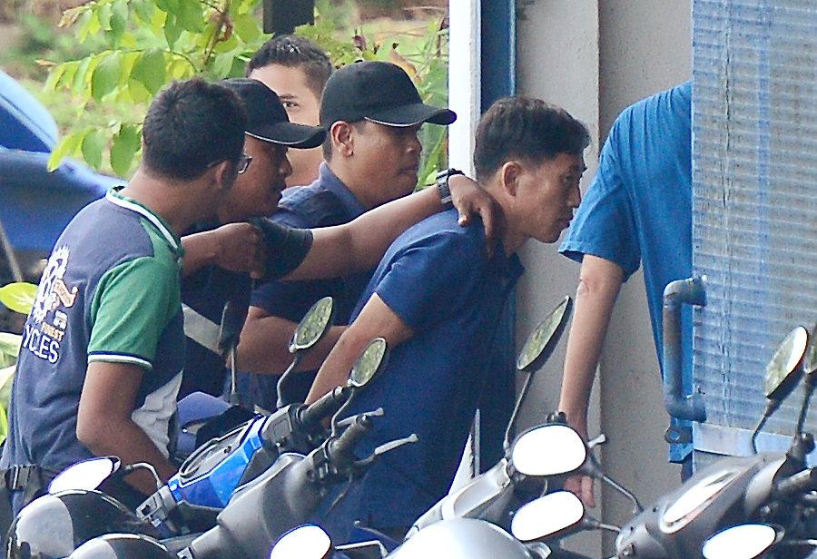  A North Korean man identified by the Malaysian police as Ri Jong Chol is taken to a police station in Sepang, Malaysia