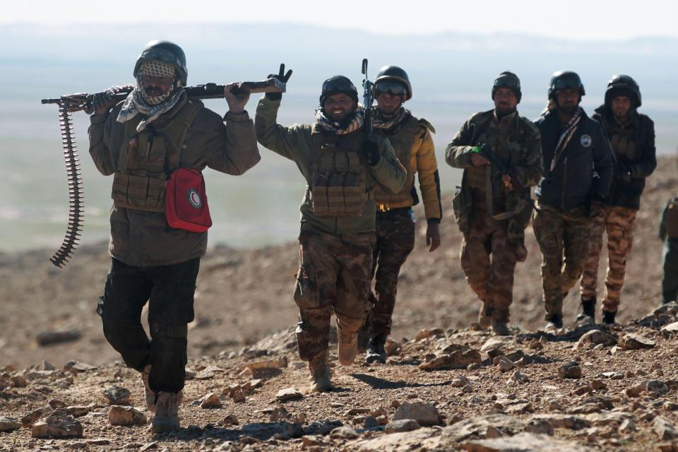  Iraqi forces, supported by the Hashed al-Shaabi paramilitaries, advance near the village of Sheikh Younis, south of Mosul