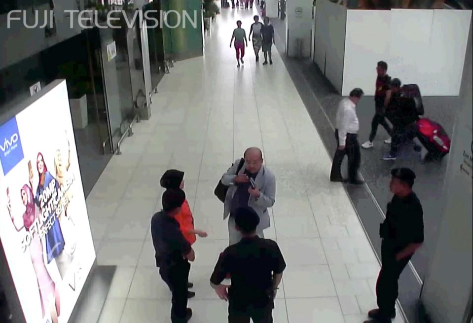  In this image taken from airport CCTV, Kim Jong-nam is seen gesturing towards his eyes as he talks to staff