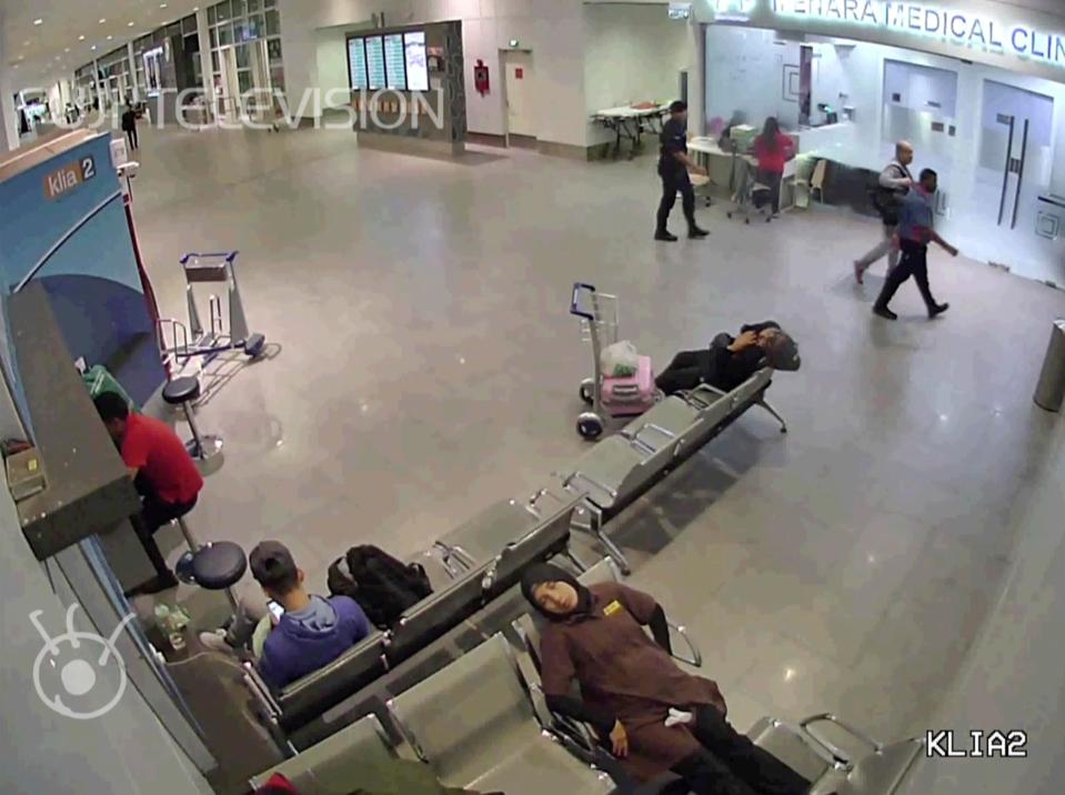  Kim Jong-nam, second from right, walks with an airport security official towards a medical clinic