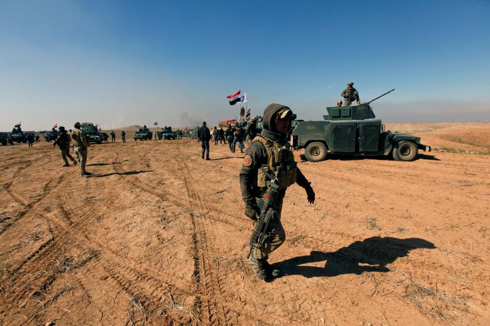  Members of the Iraqi rapid response forces gather during the battle