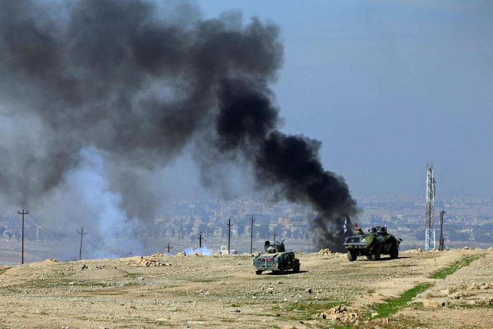  Smoke can be seen rising from clashes during a battle with Islamic State militants