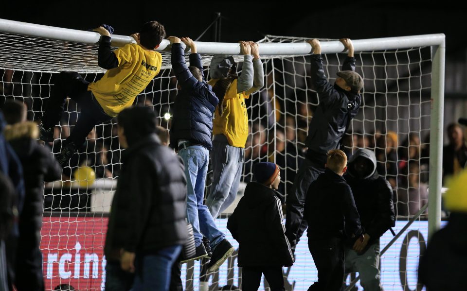  Home fans leaped onto the crossbar after the fifth round tie