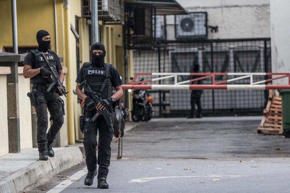  Members of the Royal Malaysian Police special operation forces stand guard outside the mortuary of the Forensic Department of the Kuala Lumpur General Hospital