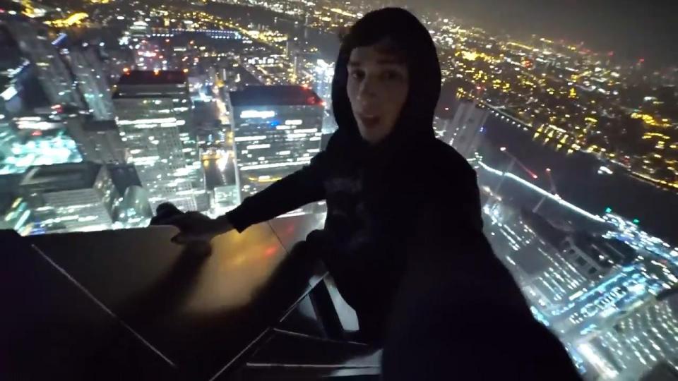 They then film themselves hanging off the 235m building